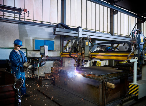 Worker looking to laser cutter