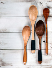 Selection of wooden spoons on rustic, vintage, natural wood - cooking and kitchen background, with design space.