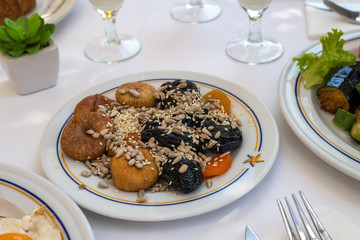 Figs, prunes and sunflower seeds and others on plate - healthy breakfast concept