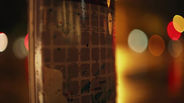 Bokeh light and map of Barcelona in the night. Wet streets and reflections in the pavement. Yellow, red and white light. Eixample grid closeup. Night in the city. Urban plan.