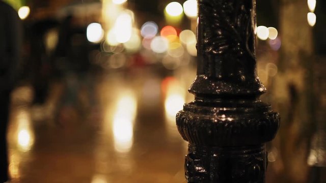 Barcelona city night. Rain in medieval town. Mirror reflects light and colour. Raindrops falling on the brick pavement. European holidays. Nightlife in Barna. Shadows and background colour textures