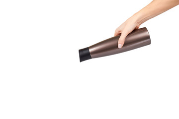 Hand with brown metal thermos, travel mug for hot drinks.