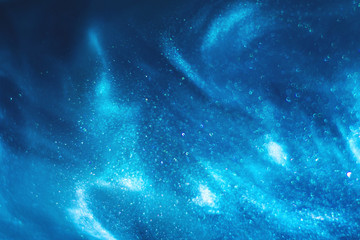 Abstract blue glitter shimmering magic underwater space bokeh background. Festive winter snowstorm....
