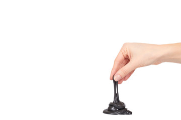 Teenager playing black slime with hand, transparent toy