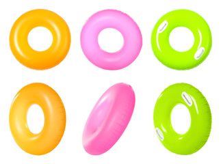 Set of bright inflatable rings on white background