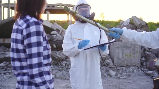 portrait scientists in protective suits and masks and dosimeter ,measure personal ionizing radiation dosimeter and examination of people for radiation sickness