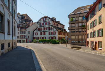 Fototapeta na wymiar Outdoor sunny street view of empty cityscape with typical building style, mixture between modern architecture and ancient wooden house, in Europe around Germany, Austria and Switzerland. 