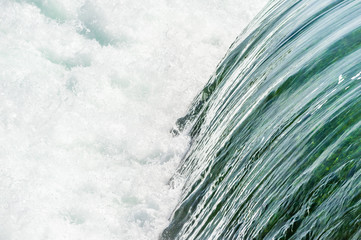 Smooth water falling into churning rapids.