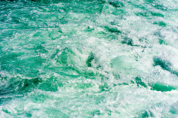 Abstract churning water and rapids in river.