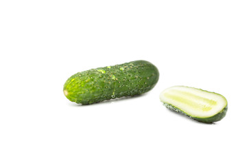 fresh ripe cucumber with water drops and half a cucumber isolated on white background