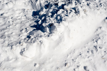 Abstract chunks of white snow with shadows.