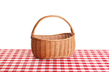 Fototapeta na wymiar Empty picnic basket on checkered tablecloth against white background