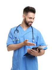 Young male doctor in uniform with clipboard isolated on white