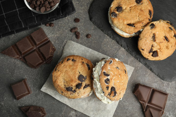 Flat lay composition with sweet delicious ice cream cookie sandwiches on table