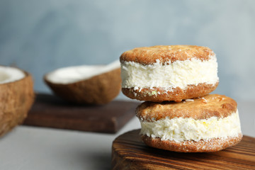 Sweet delicious ice cream cookie sandwiches on table, space for text