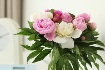 Bouquet of beautiful peonies in room, closeup
