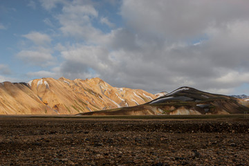 view of snowy mountains in summer from Landmannalaugar in Iceland with light of summer afternoon