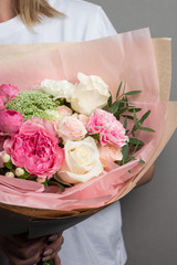 beautiful bouquet of flowers in their hands, delicate pastel shades of plants