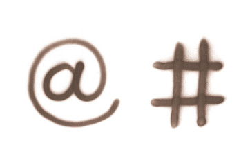 Graffiti email and hashtag sign sprayed on white isolated background