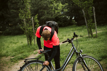 Fototapeta premium Handsome man and his bicycle in nature. Healthy life