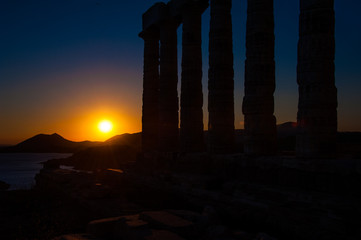 Naklejka premium Ancient Greek temple of Poseidon / Neptune, at Cape Sounion near Athens, during sunset