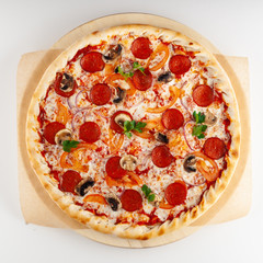Round pizza on thin dough with spicy chorizo, cheese, champignons, tomatoes, ricotta and red onion, isolated on white background