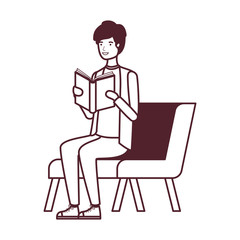 man sitting on chair with book in hands