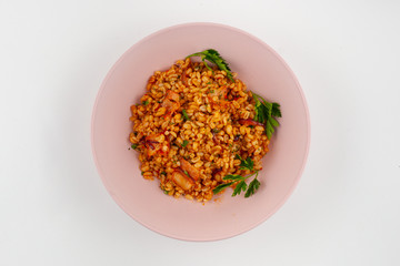 Russian steamed pearl barley with bacon, sweet and sour sauce and vegetables, isolated on white background