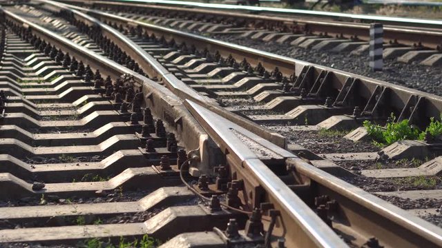 Railway rails and sleepers in summer sunny day. Close-up. Railroad track