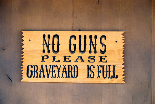 funny "no guns" sign at boothill graveyard in Tombstone, Arizona
