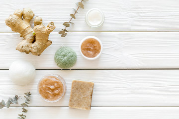Organic cosmetics with ginger and herbs on white wooden background top view mockup