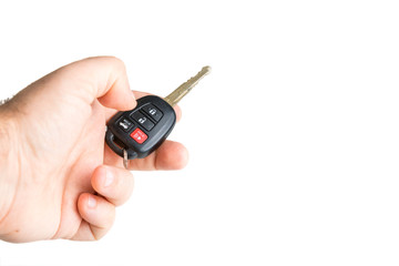 Fototapeta premium A male holding a car key isolated on a white background