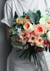 wedding bouquet in hands, bridal bouquet for the ceremony