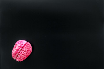 Disease of the brain concept with brain on black background top view