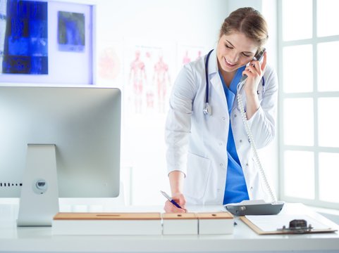 Serious Doctor On The Phone In Her Office