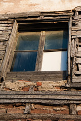 An old wooden window of a cottage house in a small village in Greece