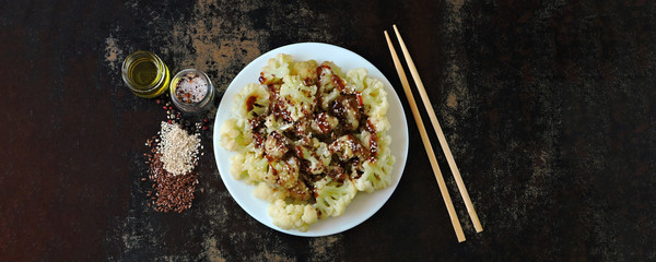 Cauliflower with olive oil, sesame and soy sauce. Vegan food. Chinese style.