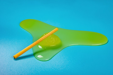 green color mini size popsicle melt on a blue background