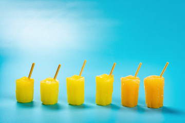 mini size popsicles stand on a blue background