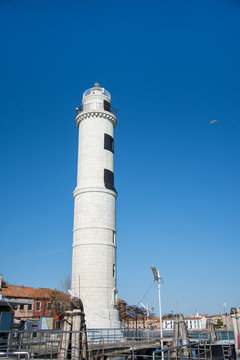 Laguna brick buildings and lighthouse of Murano in Venice in Italy,2019.