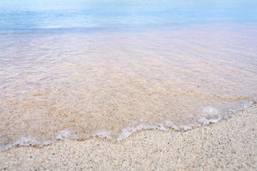 Colorful sand on a tropical beach as a blurred natural background. Copy space.