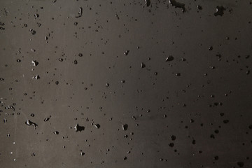 texture of black matte background with water drops, place for text, horizontal