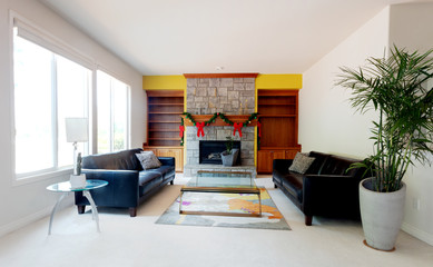 Modern home living or family room decorated with Christmas objects on fireplace