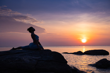 Asian girl practice Yoga on the beach Sunrise morning day