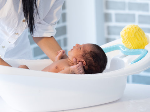 Mother Bath Asian Boy Baby Newborn On The Bathtub