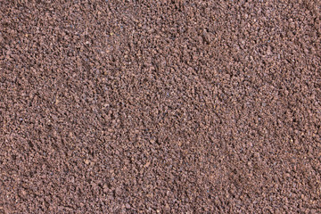 Red purple fine sand material texture pattern at construction site close-up