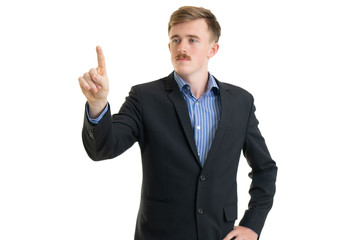 Happy young businessman in suit looking up on white background, isolated concept