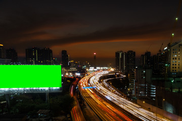 Fototapeta na wymiar Business Building Bangkok city area at night life with transportation way and big billboard green screen for logistic concept high angle bird eyes view