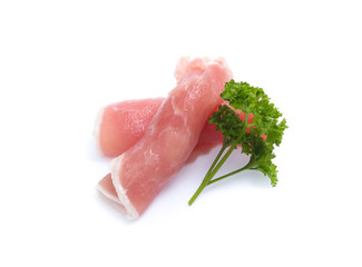 Raw pork meat with parsley herb leaves isolated on white background