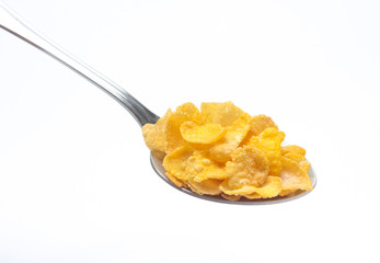 Cornflakes on spoon  isolated on white background